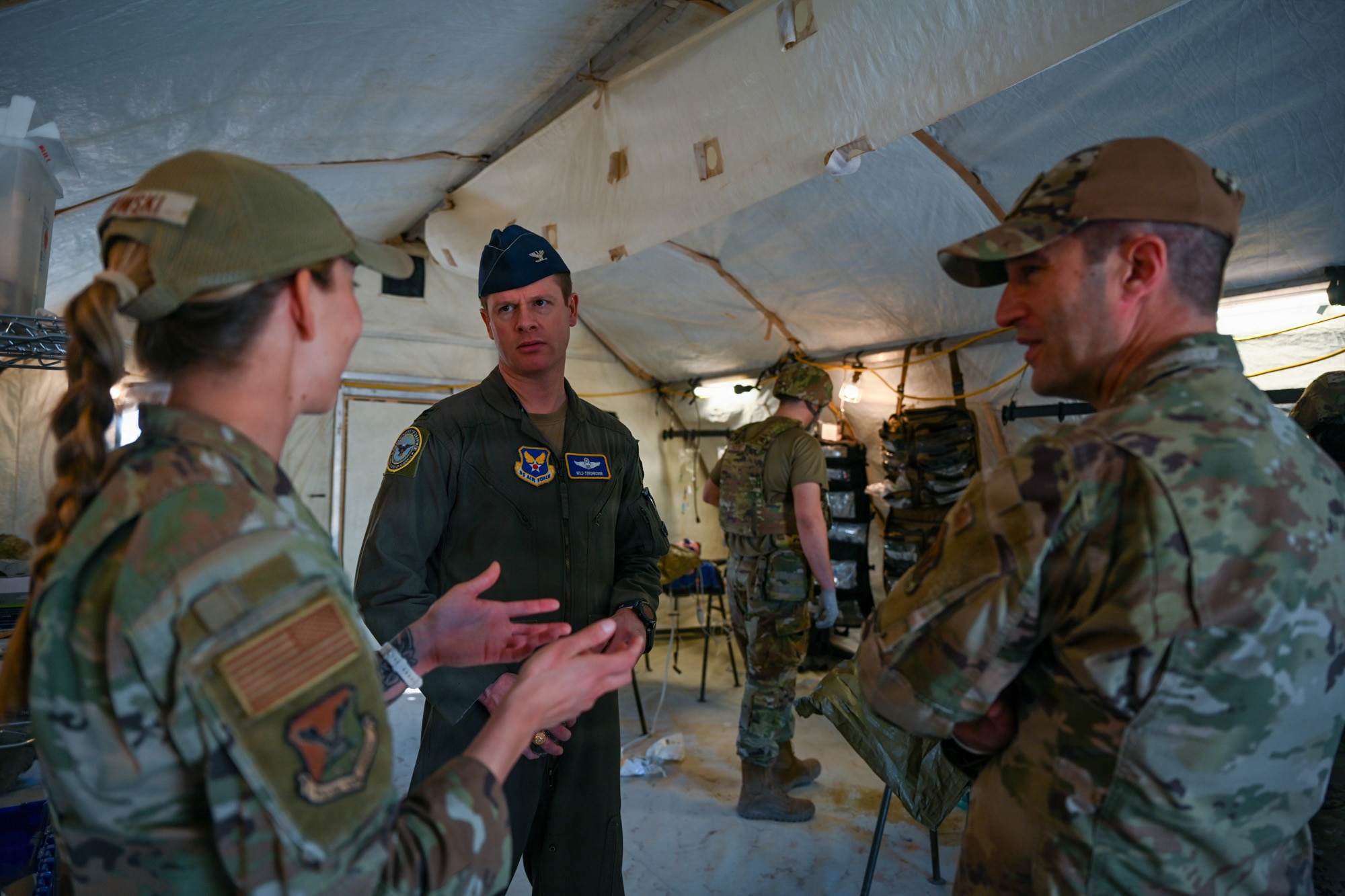 A medical planner assigned to the 31st Air Task Force discusses pre-deployment training objectives with observers during a field training exercise at Tyndall Air Force Base, Florida, Feb. 13, 2026. Through rigorous field training exercises, 31 ATF readies itself to provide combatant commanders with options to ensure peace through strength in any area of responsibility. (U.S. Air Force photo by Senior Airman Ty Pilgrim)