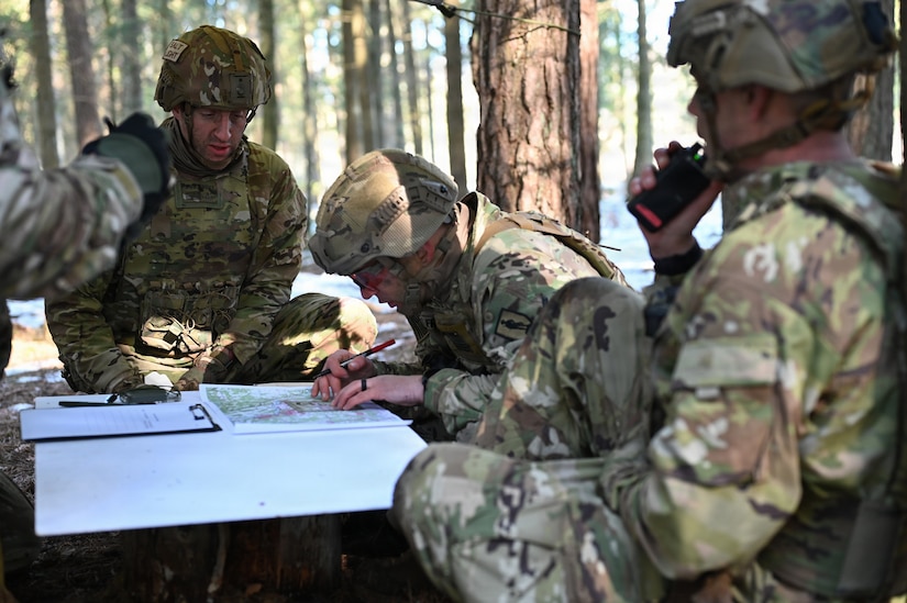 Members of a Pennsylvania Army National Guard squad plot a point on a map during the Lithuanian Land Forces Best Infantry Squad Competition in Rukla, Lithuania, March 5, 2026. Pennsylvania Army Guard Soldiers placed second among foreign teams during the multinational competition. The Pennsylvania National Guard and Lithuania have been partners in the Department of Defense National Guard State Partnership Program since 1993, conducting joint training and exchanges that strengthen military cooperation and interoperability. (U.S. Army National Guard photo by Sgt. 1st Class Tessa Whittlesey)