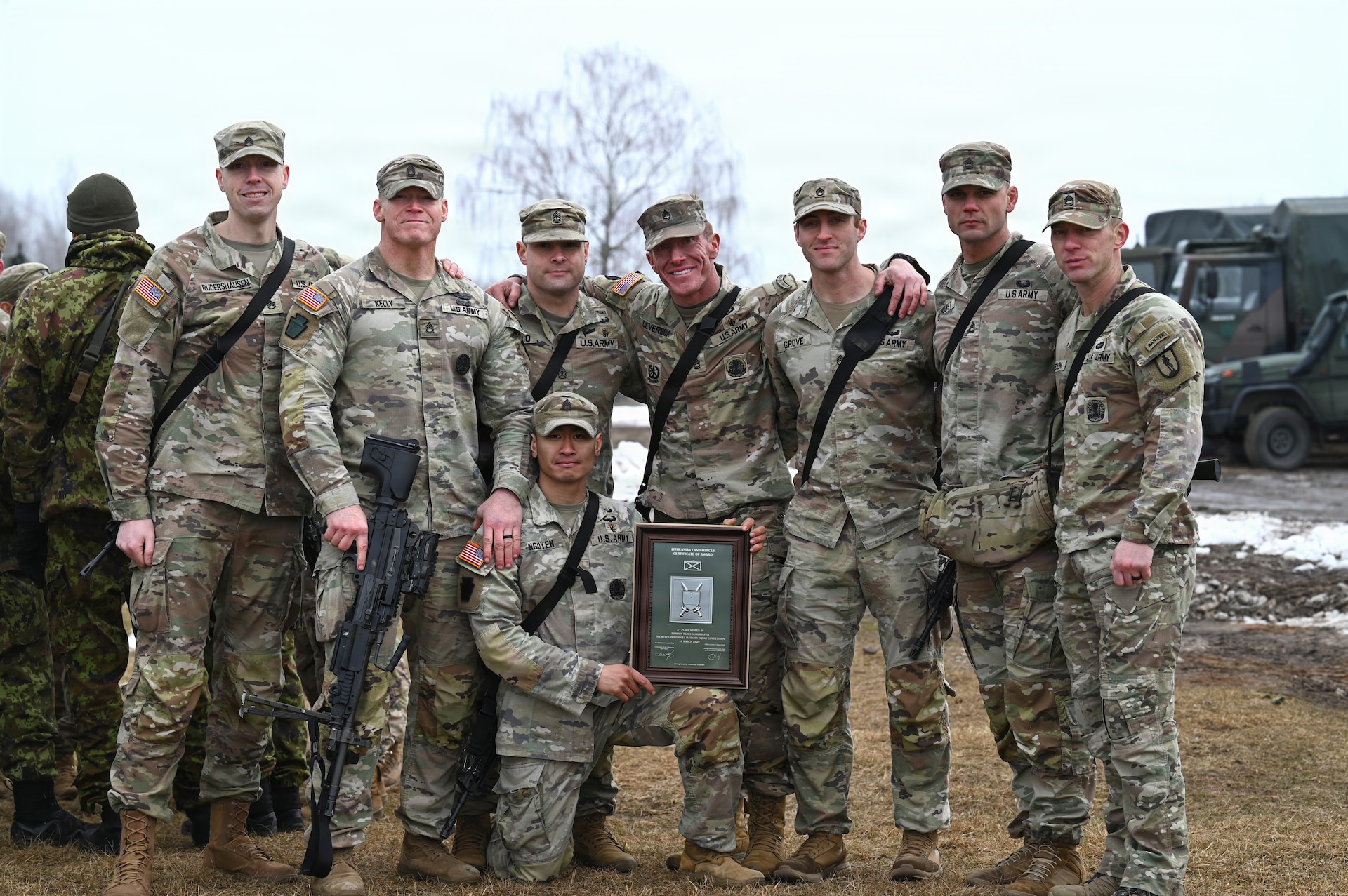 An eight-person squad with the Pennsylvania Army National Guard stands together for a photo at the conclusion of the Lithuania Land Forces Best Infantry Squad Competition in Rukla, Lithuania, March 6, 2026. Pennsylvania Army Guard Soldiers placed second among foreign teams during the multinational competition. The Pennsylvania National Guard and Lithuania have been partners in the Department of Defense National Guard State Partnership Program since 1993, conducting training and exchanges that strengthen military cooperation and interoperability.(U.S. Army National Guard photo by Sgt. 1st Class Amber Peck)