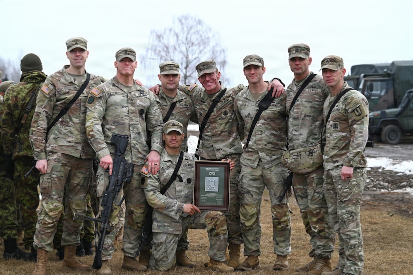 An eight-person squad with the Pennsylvania Army National Guard stands together for a photo at the conclusion of the Lithuania Land Forces Best Infantry Squad Competition in Rukla, Lithuania, March 6, 2026. Pennsylvania Army Guard Soldiers placed second among foreign teams during the multinational competition. The Pennsylvania National Guard and Lithuania have been partners in the Department of Defense National Guard State Partnership Program since 1993, conducting training and exchanges that strengthen military cooperation and interoperability.(U.S. Army National Guard photo by Sgt. 1st Class Amber Peck)