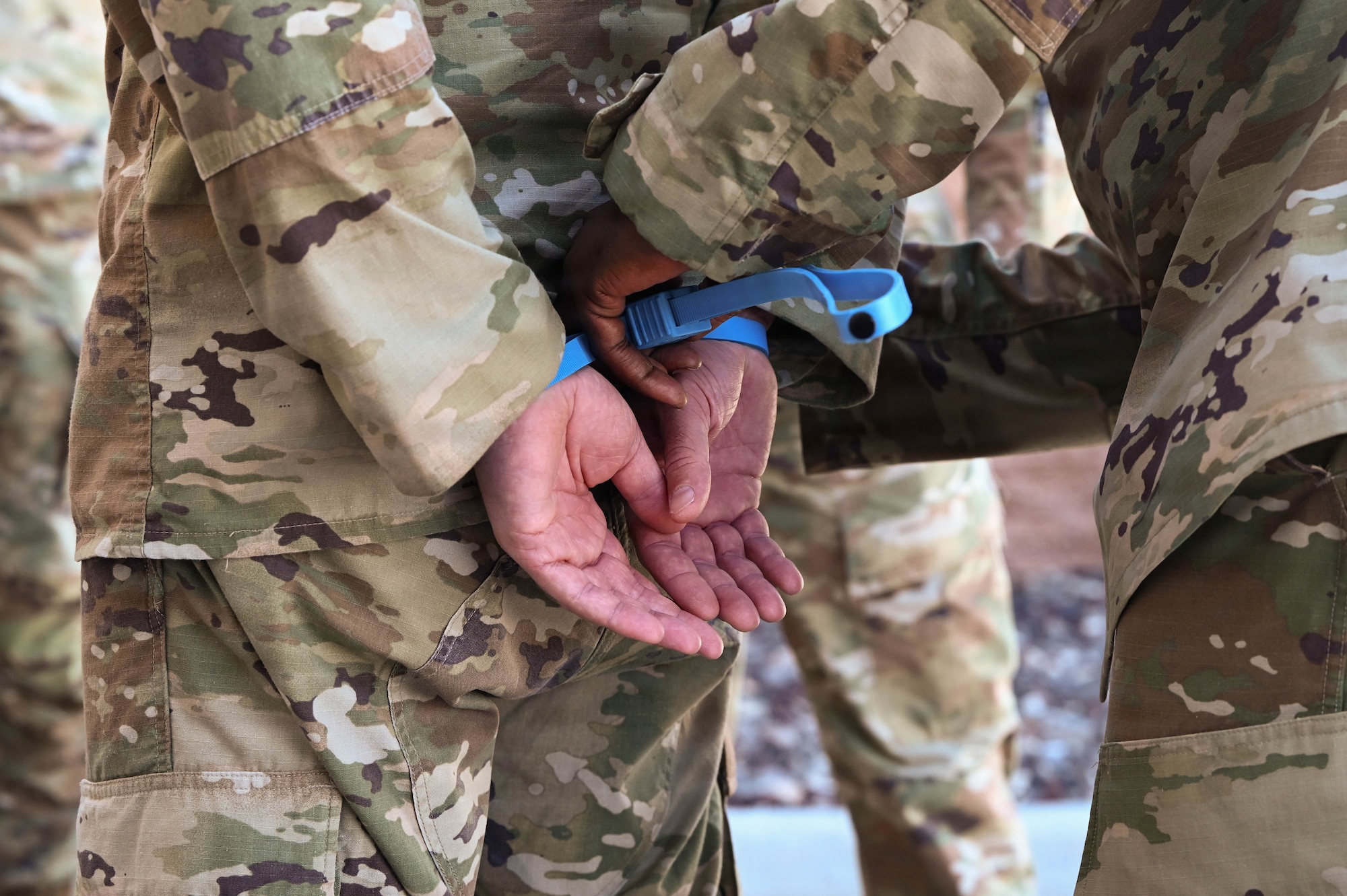 Person zip tying Person