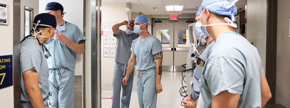 Surgeons in the hallway near an operating room at Naval Medical Center San Diego.