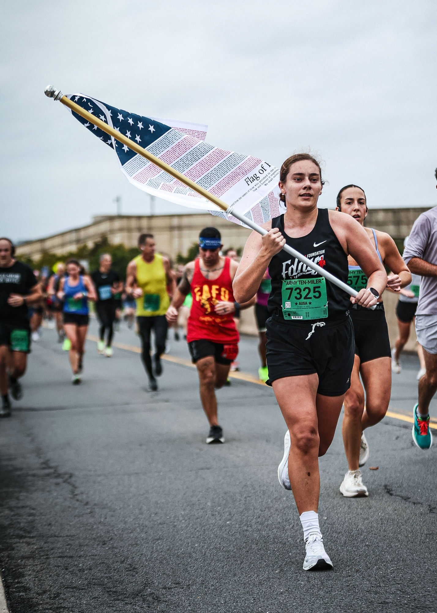 Born carries a flag during a run.