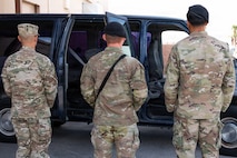 People looking at car