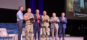 Honorable Matt Lohmeier, Under Secretary of the Air Force, (left) and Retired U.S. Air Force Lt. Gen. David A. Deptula, Mitchell Institute for Aerospace Studies dean, (right) present the 2025 General Atomics U.S. Space Force Unit of the Year award to U.S. Space Force Lt. Col. Andrew Singleton, 2nd Space Launch commander, (second from left) at Air & Space Forces Association 2026 Warfare Symposium in Aurora, Colo. Feb. 24, 2026. The trophy was presented to the squadron at the AFA Warfare Symposium in recognition of their exceptional contributions to the U.S. Space Force mission and embodiment of its core values. (Courtesy Photo)