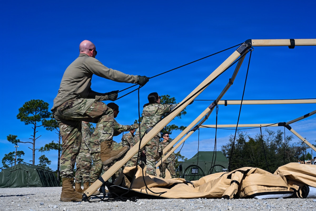 U.S. Air Force medics assigned to the 31st Combat Air Base Squadron establish an air transportable clinic during the 31st Air Task Force’s second field training exercise at Tyndall Air Force Base, Florida, Feb. 7, 2026. The facility, easily palletized and shipped as cargo, is an Air Force medical capability containing defibrillators, ventilators, and EKGs as well as an array of medicine and other supplies. (U.S. Air Force photo by Senior Airman Ty Pilgrim)