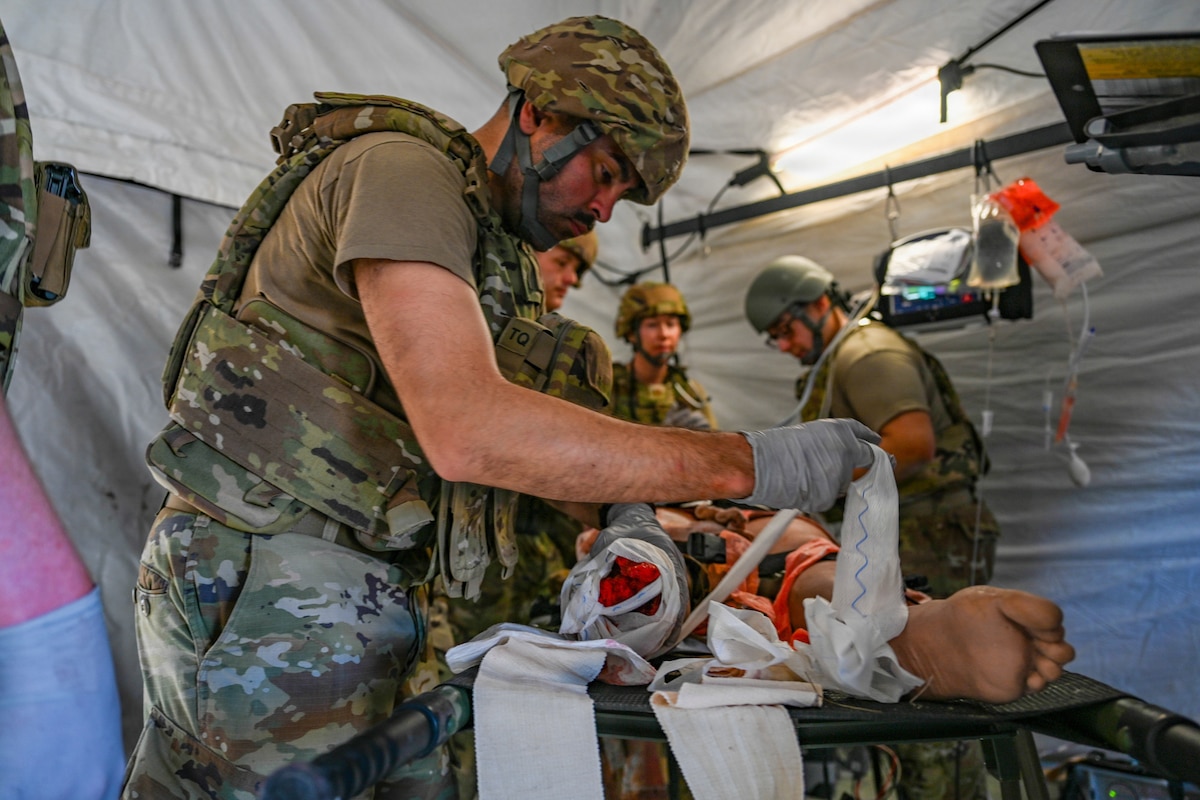 U.S. Air Force medics assigned to the 31st Combat Air Base Squadron treat a simulated patient during training with Special Operations Forces Medical Element during the 31st Air Task Force’s second field training exercise at Tyndall Air Force Base, Florida, Feb. 9, 2026. This collaboration with the 1st Special Operations Medical Group demonstrated how 31 ATF is evolving to meet updated national priorities and more efficiently use Air Force talent and resources. (U.S. Air Force photo by Senior Airman Ty Pilgrim)