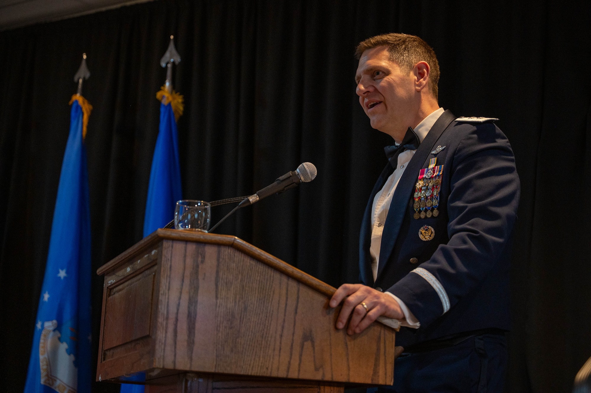The guest speaker of the graduation ceremony delivers remarks at a podium.