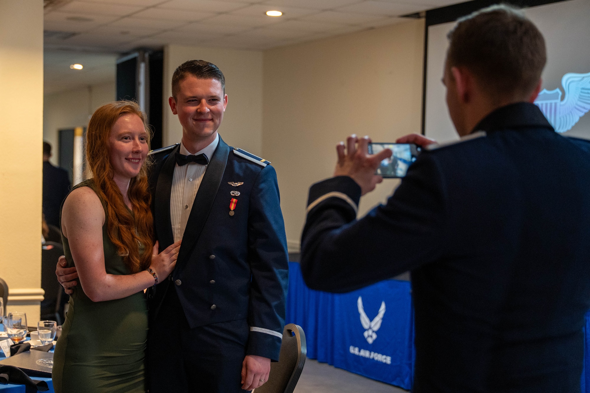 A graduating pilot poses for a photo with his guest.