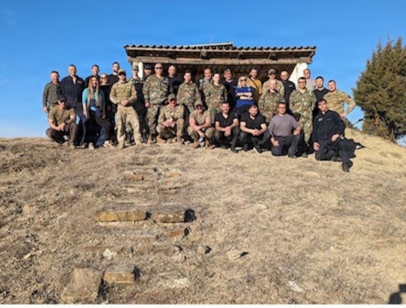 Group photo of representatives from North Macedonia’s Protection and Rescue Directorate (PRD), Ministry of Interior (MOI), Ministry of Defence (MOD), and U.S. Humanitarian Mine Action (HMA) personnel from the Vermont Air National Guard, standing together with partners from the Golden West Humanitarian Foundation in North Macedonia.