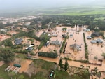 An MH-65 Dolphin helicopter crew assigned to Coast Guard Air Station Barbers Point in Kapolei, Hawaii, flies over a flooded neighborhood in Waialua on the north shore of Oahu March 20, 2026. The Honolulu Department of Emergency Management issued mandatory evacuations for communities in Waialua and Haleiwa following heavy rainfall and flooding across Oahu. (U.S. Coast Guard photo, courtesy Air Station Barbers Point)