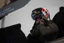 A U.S. Air Force fighter pilot assigned to the 493rd Fighter Squadron dons his flight helmet in preparation for a training sortie during Exercise Cold Response 26 at Ørland Air Force Station, Norway, March 12, 2026.