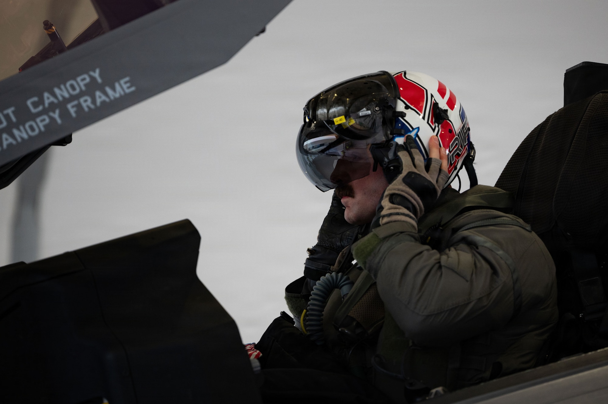 A U.S. Air Force fighter pilot assigned to the 493rd Fighter Squadron dons his flight helmet in preparation for a training sortie during Exercise Cold Response 26 at Ørland Air Force Station, Norway, March 12, 2026.