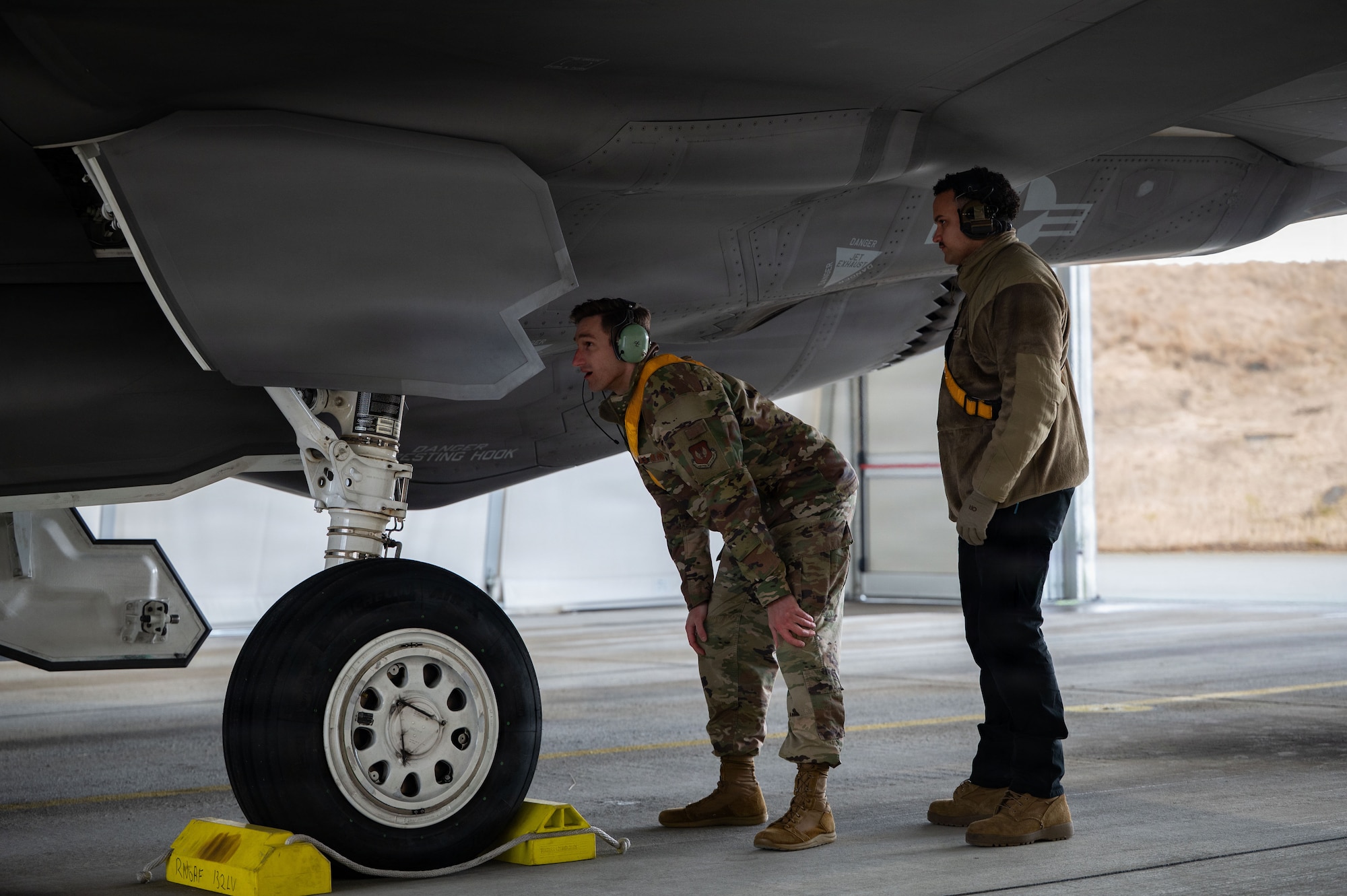 U.S. Air Force 2nd Lt. Chris Stallings, 48th Fighter Wing contracting officer, and Staff Sgt. Richard Johnson, 493rd Fighter Generation Squadron dedicated crew chief, inspect a F-35A Lightning II aircraft before launch during Exercise Cold Response 26 at Ørland Air Force Station, Norway, March 10, 2026.