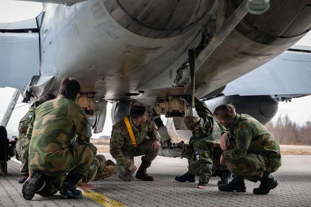 Finnish Air Force, Royal Norwegian Air Force and U.S. Air Force members inspect a Finnish Air Force F/A-18C Hornet aircraft assigned to the Karelia Air Wing during Exercise Cold Response 26 at Ørland Air Force Station, Norway, March 13, 2026.