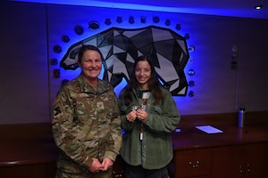 Staff Sgt. Madison Harper, 168th Force Support Squadron, receives a commander’s coin from Col. Jennifer Casillo, 168th Wing deputy commander, for graduating as the top student after earning a 100 percent score on all graded assignments during the Personnel Apprentice Course.