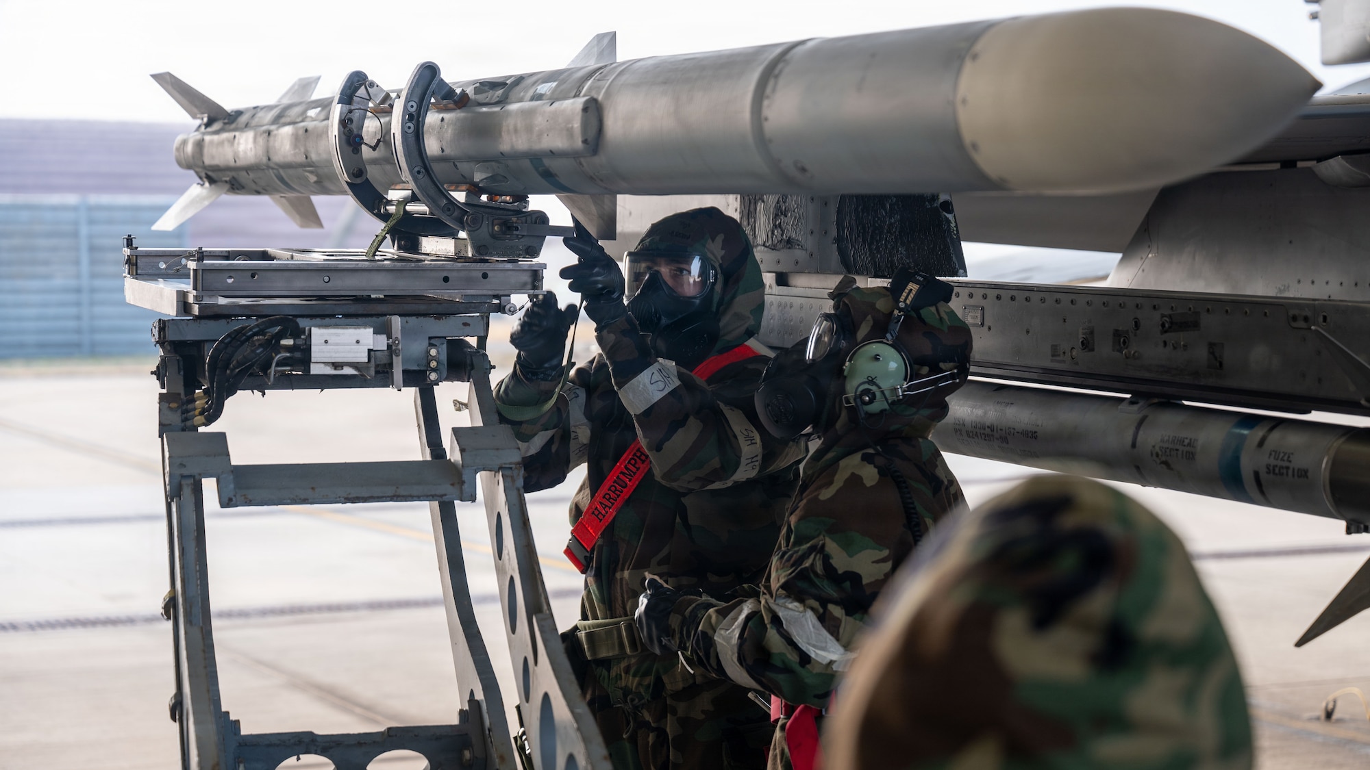 U.S. Air Force Airmen assigned to the 36th Fighter Generation Squadron, installs a missile during exercise Freedom Shield 26 at Osan Air Base, Republic of Korea, March 12, 2026. Maintainers and pilots worked together to launch and recover aircraft while operating in Mission Oriented Protective Posture gear during simulated wartime scenarios. (U.S. Air Force photo by Senior Airman Rome Bowermaster)