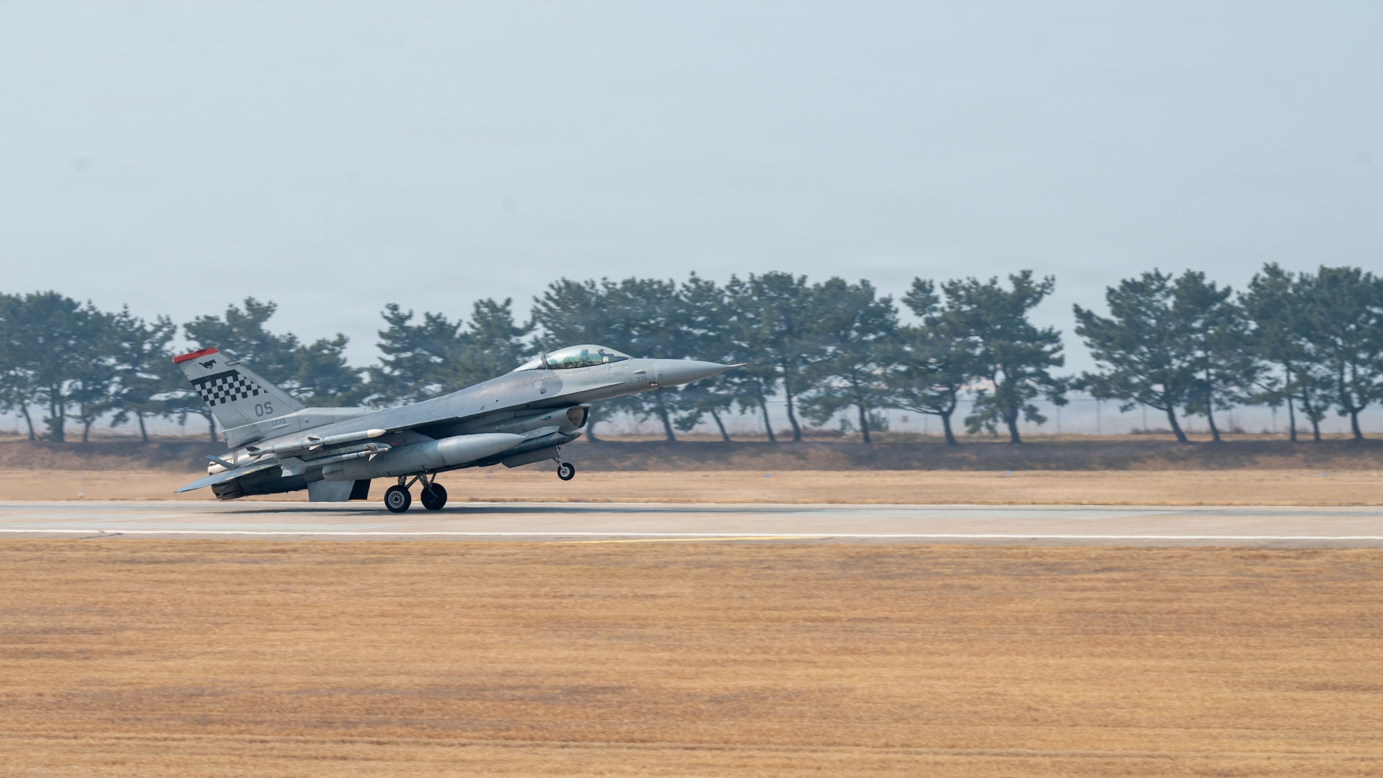 A U.S. Air Force F-16 Fighting Falcon lands on runway during exercise Freedom Shield 26 at Osan Air Base, Republic of Korea, March 12, 2026. The exercise tested the ability of Osan Airmen to rapidly generate combat airpower while operating away from their primary installation. (U.S. Air Force photo by Senior Airman Rome Bowermaster)