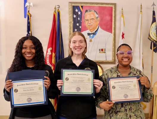 Referral coordinator Jazlyn Antoinette Tharp (left), first-place winner, Hospital Corpsman 3rd Class Kaitlyn D. Miller (center), second-place winner, and Hospital Corpsman 1st Class Meosha Williams (right), third-place winner, pose during the command process improvement fair at Navy Medicine Readiness and Training Command Twentynine Palms, March 13, 2026. (U.S. Navy photo by Christopher Jones, NMRTC / Naval Hospital Twentynine Palms public affairs officer).