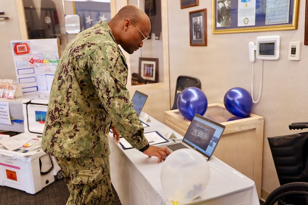 Hospital Corpsman 3rd Class Michael Harris interacts with a virtual process improvement project presentation from Navy Medicine Readiness and Training Detachment Bridgeport during the command process improvement fair at Navy Medicine Readiness and Training Command Twentynine Palms, March 13, 2026. (U.S. Navy photo by Christopher Jones, NMRTC / Naval Hospital Twentynine Palms public affairs officer).