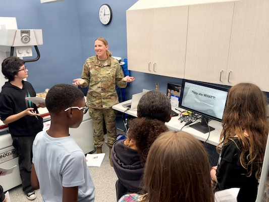 Students from W.T. Sampson Elementary and High School observe diagnostic X-ray images while participating in the “They Ate What?” activity led by U.S. Army Maj. Catherine Barich, veterinarian, at the veterinary clinic onboard Naval Station Guantanamo Bay, Cuba, March 10, 2026. The interactive session introduced students to radiographic imaging and how it is used to identify injuries, ingested foreign objects and other medical conditions in animals. The visit was part of a field trip hosted by U.S. Navy Medicine Readiness and Training Command Guantanamo Bay to provide hands-on exposure to careers in military medicine. (U.S. Navy photo by Emily McCamy)