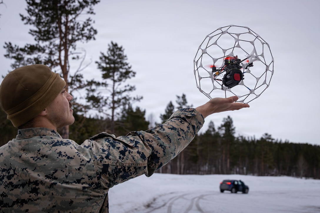U.S. Marine Corps Cpl. Jayden Flora, the innovation lead with Unmanned Systems Center of Excellence, 2nd Marine Division, lifts an Orb Jawbreaker drone in Setermoen, Norway, March 17, 2026. Researchers with Operational Energy Innovation, out of the U.S. Naval Research Laboratory, tested their Data Acquisition System using an Event Based Sensor to track drones in low-light and nighttime conditions to enhance counter Unmanned Aircraft Systems capabilities, remaining lethal in the era of rapid growing, technology-driven conflict, during exercise Cold Response 26. A key component of NATO's enhanced vigilance activity Arctic Sentry, exercise Cold Response 26 is a Norwegian-led winter military exercise designed to enhance collective defense capabilities and ensure U.S. readiness to rapidly deploy and seamlessly operate alongside NATO Allies in challenging arctic conditions. Flora is a native of Florida. (U.S. Marine Corps photo by Sgt. Alexis French)