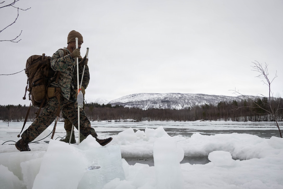 U.S. Marine Corps Cpl. Cody Johnson, a utilities systems technician with Headquarters Battalion, 2nd Marine Division, jumps into icy water during an ice-breaker drill in Setermoen, Norway, March 20, 2026. The drill teaches Marines how to survive and regain composure after falling through ice, an essential Arctic survival skill learned during exercise Cold Response 26. A key component of NATO's enhanced vigilance activity Arctic Sentry, exercise Cold Response 26 is a Norwegian-led winter military exercise designed to enhance collective defense capabilities and ensure U.S. readiness to rapidly deploy and seamlessly operate alongside NATO Allies in challenging arctic conditions. (U.S. Marine Corps photo by Sgt. Alexis French)