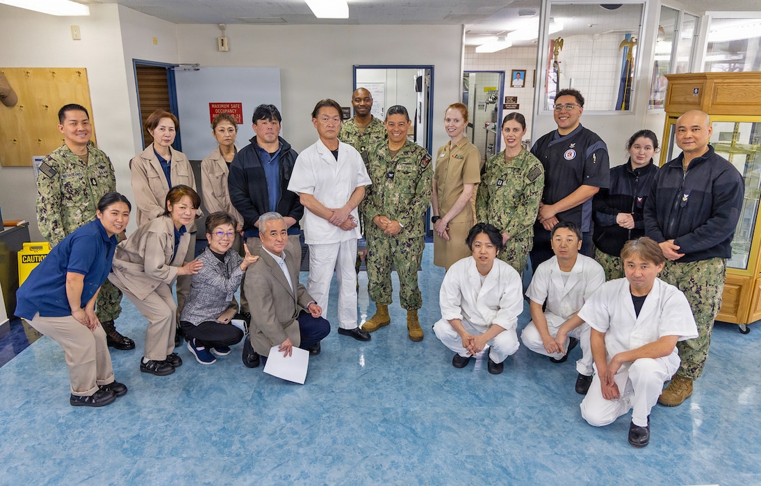 YOKOSUKA, Japan (March 16, 2026) – Mr. Katsuo Konno, a master labor contract employee and galley supervisor at U.S. Naval Hospital Yokosuka, stands with staff following a recognition ceremony at the hospital. Konno was honored for his leadership and dedication to galley operations, supporting both patient care and operational readiness. U.S. Naval Hospital Yokosuka ensures warfighter readiness and delivers high-quality health care to forward-deployed forces and their families. (U.S. Navy photo by Daniel Taylor/USNMRTC Yokosuka Public Affairs)
