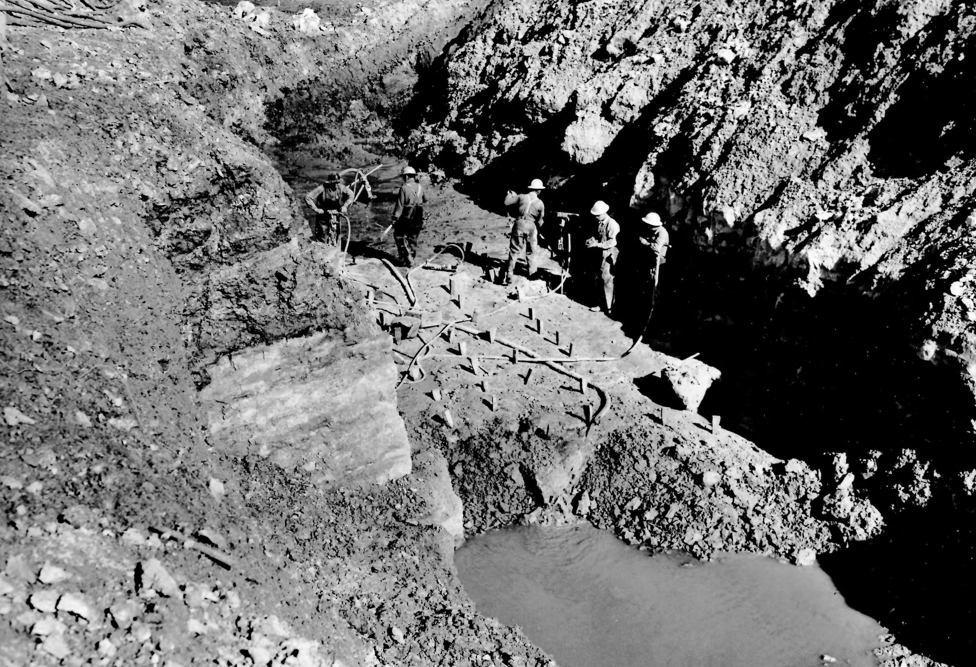 Crews drill rock on the north side of the Elk River Dam core trench in February 1951 during construction of the dam. Work to dam the Elk River began in early 1950. This project was completed in September 1952. The construction of the Elk River Dam created Woods Reservoir, which has since supplied cooling water to the test facilities at Arnold Air Force Base, Tennessee. Arnold AFB is the headquarters of the Arnold Engineering Development Complex. (U.S. Air Force photo)
