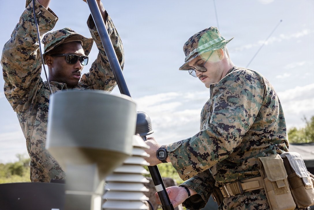 U.S. Marine Corps Gunnery Sgt. McDavid Charleston, left, and Cpl. Clayton Peters, both assigned to Battlespace Surveillance Company, 1st Intelligence Battalion, I Marine Expeditionary Force Information Group establishes a maritime sensing command operations center during a BSC field exercise at Marine Corps Base Camp Pendleton, California, March 09, 2026. The BSC field exercise refines the ability to conduct maritime sensing in a degraded environment and core mission essential tasks in preparation for future operations. (U.S. Marine Corps photo by Sgt. Peyton Kahle)