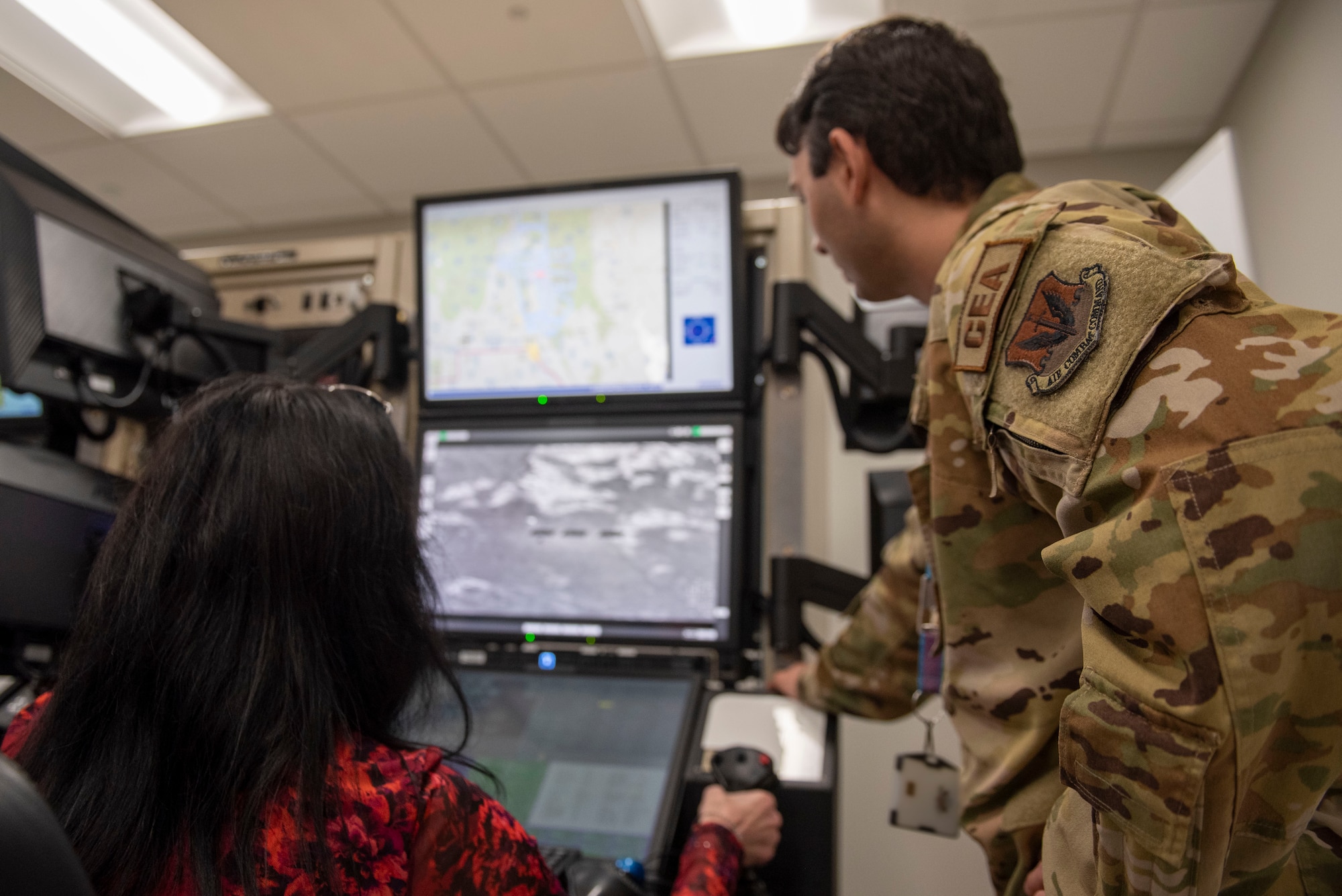 From right, Staff Sgt. Stephen Yarbrough, 50th Attack Squadron non-commissioned officer in charge of weapons and tactics, guides Kim Hatchell, 20th Fighter Wing honorary commander, through how to operate a Ground Control Station simulator at Shaw Air Force Base, S.C., March 9, 2026.