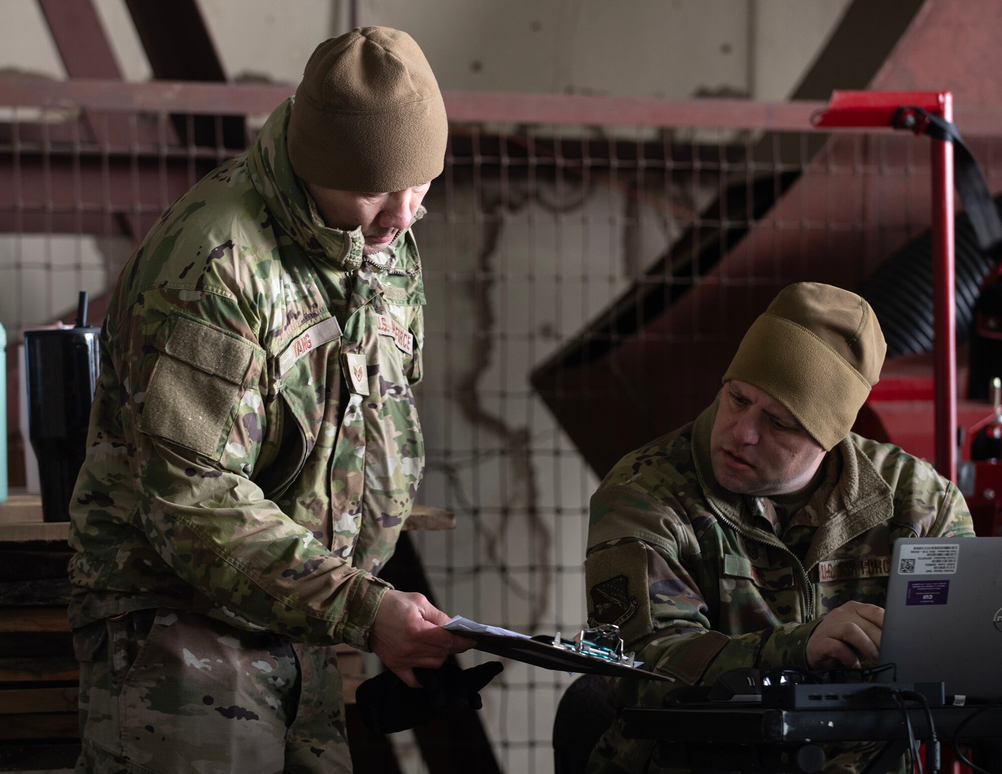 U.S. Air Force Master Sgt. Matthew Mohs, right, 133rd Logistics Readiness Squadron, reviews documents in St. Paul, Minn., Feb. 19, 2026.