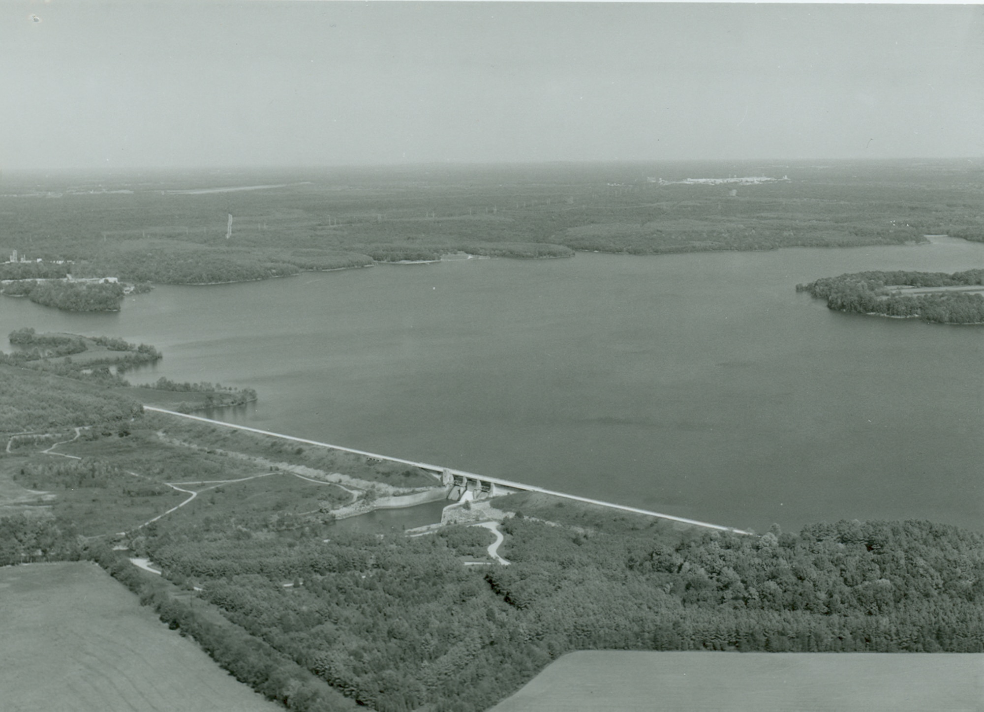 Much of the acreage comprising Woods Reservoir is seen in this aerial photo from the early 1980s. Work to dam the Elk River began in early 1950. This project was completed in September 1952. The construction of the Elk River Dam created Woods Reservoir, which has since supplied cooling water to the test facilities at Arnold Air Force Base, Tennessee. Arnold AFB is the headquarters of the Arnold Engineering Development Complex. (U.S. Air Force photo)