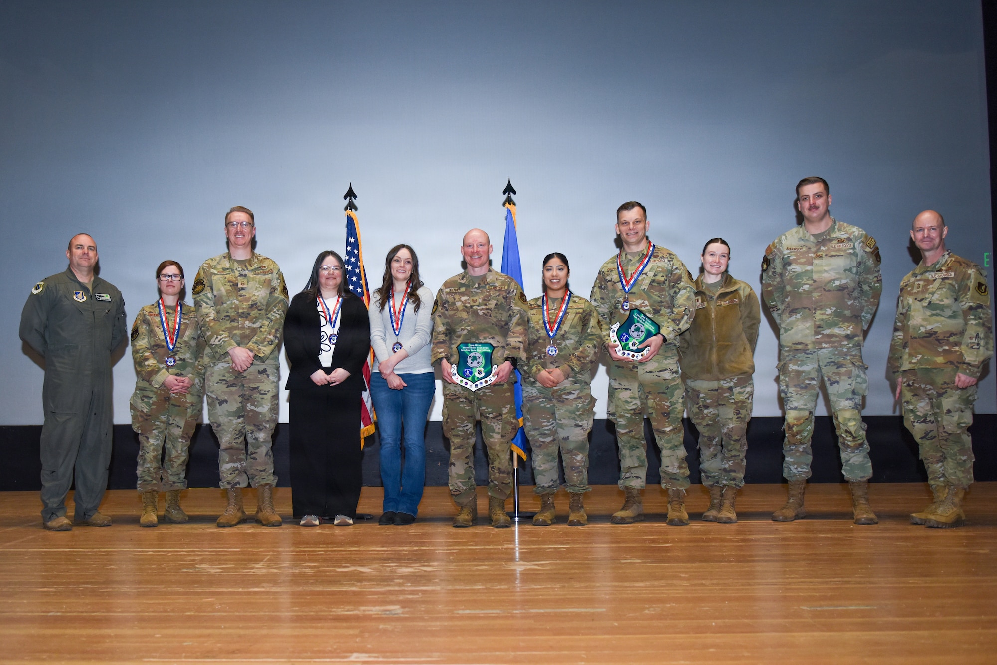 U.S. Air Force Col. Charles Schuck, 3rd Wing Commander, and 3rd Wing Command Chief Master Sgt. Michael Macneil, pose with the 2025 annual awards winners at Joint Base Elmendorf-Richardson, Alaska, Feb. 28, 2026. The annual awards recognize the winners’ accomplishments and contributions to JBER’s mission. (U.S. Air Force photo by Nicholas Holland)