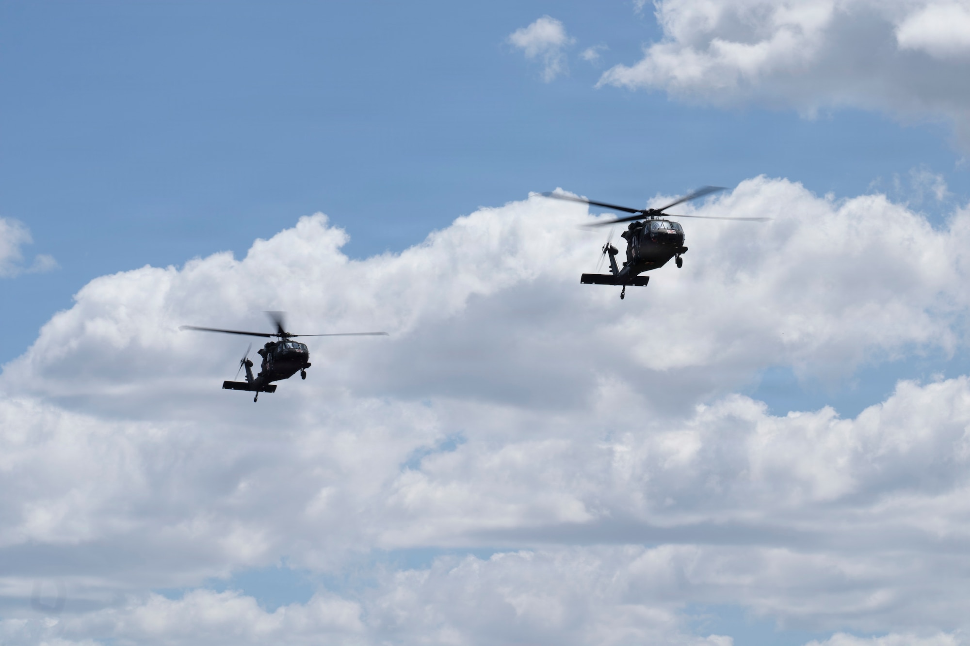 A photo of two military helicopters flying