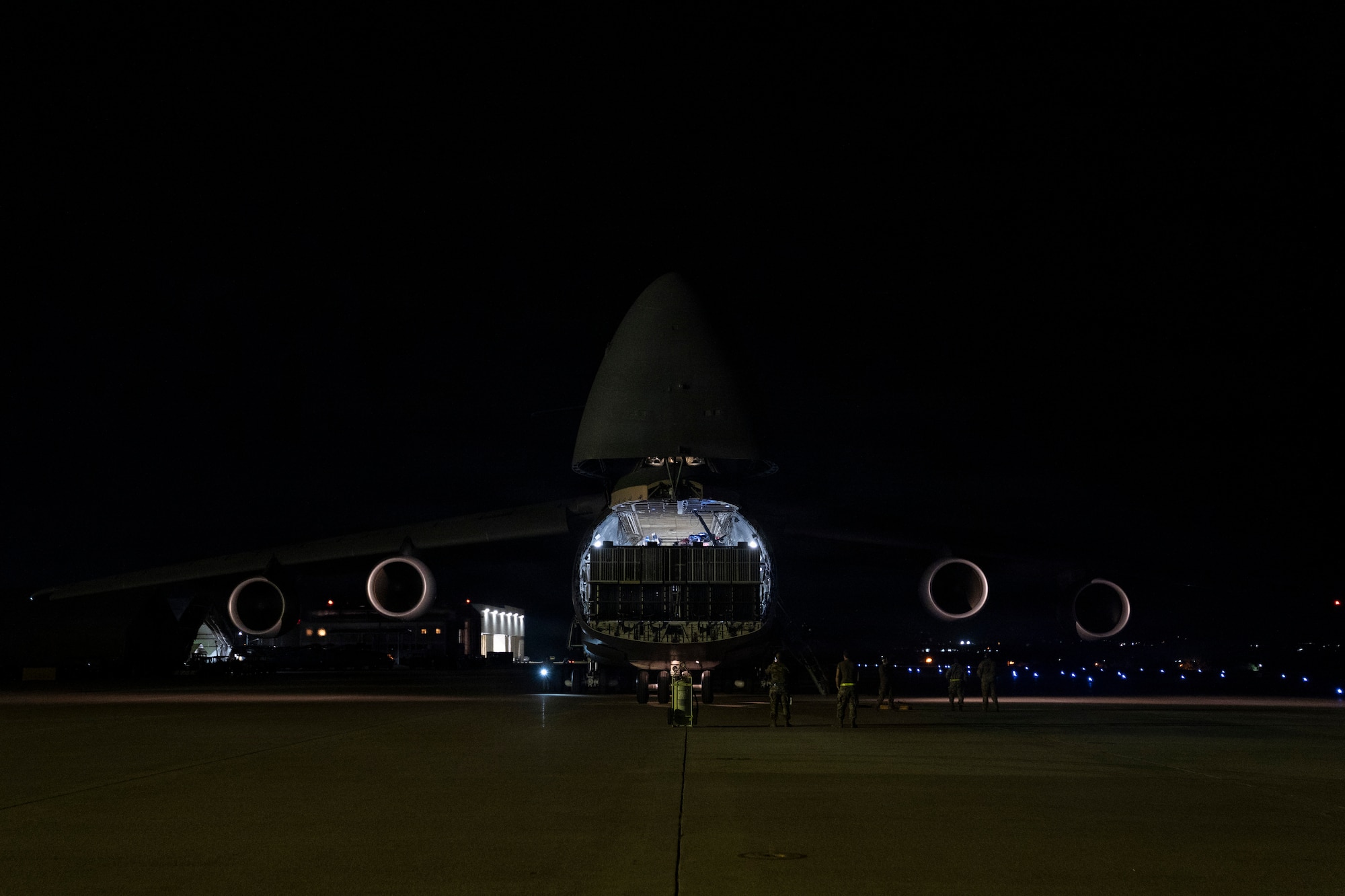 A photo of a large military plane at night