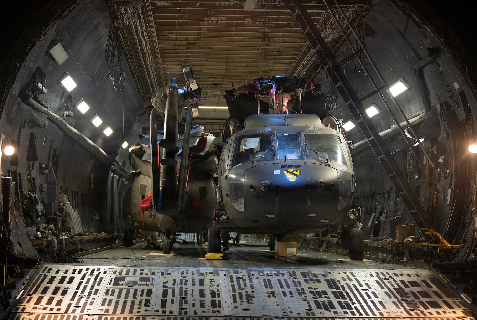 Military helicopters inside of a military plane