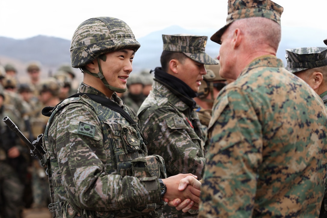 U.S. Marine Corps Lt. Gen. Roger Turner, III Marine Expeditionary Force Commander, gives a challenge coin to a Republic of Korea Marine Corps Marine with 1st ROK Marine Division during exercise Freedom Shield 26 in Pohang, Republic of Korea, March 16, 2026. The exercise prepares participants to respond to a range of emerging threats, including cyber warfare, missile defense, and asymmetric tactics, ensuring a comprehensive approach to national defense.  

(U.S. Marine Corps photo by Master Sgt. Daniel Wetzel)