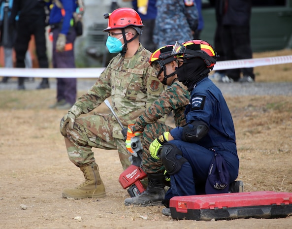 U.S. Air Force Tech. Sgt. Waylon Dashiell, 141st Civil Engineers, Washington Air National Guard, stands ready with the Bangkok Fire and Rescue Department during the Humanitarian Assistance Disaster Relief Demonstration, part of Exercise Cobra Gold 26 at the Disaster Relief Training Centre, Phanom Sarakham District, Chachoengsao, Thailand, Feb. 27, 2026.