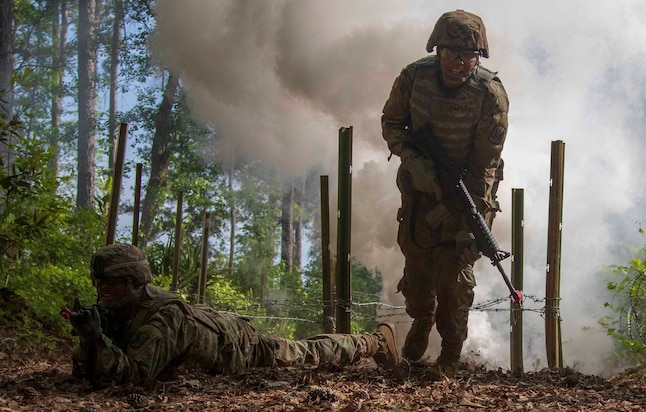 Georgia Army National Guardsman Spc. Michael Saunders and Spc. Nyvasia Park, both logistics specialists with the Marietta-based, 1st Battalion, 171st Aviation Regiment, prepare to move to the next objective during Individual Movement Technique training at Fort Stewart, Ga., on April 17, 2019.   The unit is conducting additional pre-mobilization training prior to their upcoming activation and deployment to Kosovo.