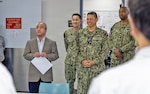 YOKOSUKA, Japan (March 16, 2026) – Mr. Katsuo Konno, a master labor contract employee and galley supervisor at U.S. Naval Hospital Yokosuka, is recognized as Mr. Tomokazu Watanabe, a galley administrative specialist, reads remarks highlighting his contributions during a ceremony at the hospital. Konno was honored for his leadership, dedication and support to galley operations, which directly contribute to patient care and medical readiness. U.S. Naval Hospital Yokosuka ensures warfighter readiness and delivers high-quality health care to forward-deployed forces and their families. (U.S. Navy photo by Daniel Taylor/USNMRTC Yokosuka Public Affairs)
