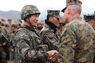 U.S. Marine Corps Lt. Gen. Roger Turner, III Marine Expeditionary Force Commander, gives a challenge coin to a Republic of Korea Marine Corps Marine with 1st ROK Marine Division during exercise Freedom Shield 26 in Pohang, Republic of Korea, March 16, 2026. The exercise prepares participants to respond to a range of emerging threats, including cyber warfare, missile defense, and asymmetric tactics, ensuring a comprehensive approach to national defense.  

(U.S. Marine Corps photo by Master Sgt. Daniel Wetzel)