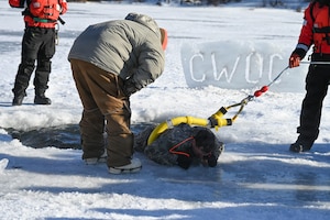 Cold weather course participants pull members out of the ice in a training scenario.