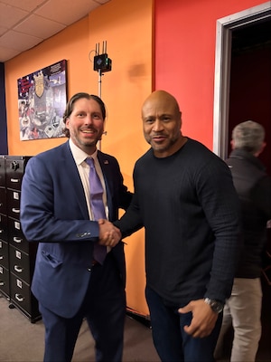 Naval Criminal Investigative Service Division Chief David Vaughan shakes hands with LL Cool J on the set of CBS' NCIS television series.