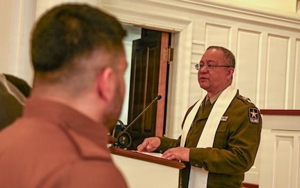 U.S. Army Maj. Ceasar Pajarillo, Indiana National Guard Chaplain assigned to Joint Task Force - District of Columbia, delivers a message during the wedding ceremony of Spc. Ester Henriquez and Hasan Alpkan at the Old Post Chapel, Fort Myer, Virginia, March 21, 2026. About 2,700 National Guard members support the D.C. Safe and Beautiful mission, assisting the Metropolitan Police Department in maintaining public safety for residents, commuters and visitors throughout the District.