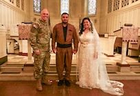 U.S. Army Brig. Gen. Leland D. Blanchard II, Commanding General (interim) of the District of Columbia National Guard, Hasan Alpkan and Spc. Ester Henriquez, an Indiana National Guard member assigned to Joint Task Force - DC, pose for a photo after their wedding ceremony at the Old Post Chapel on Fort Myer, Virginia, March 21, 2026. About 2,700 National Guard members support the D.C. Safe and Beautiful mission, assisting the Metropolitan Police Department in maintaining public safety for residents, commuters and visitors throughout the District.