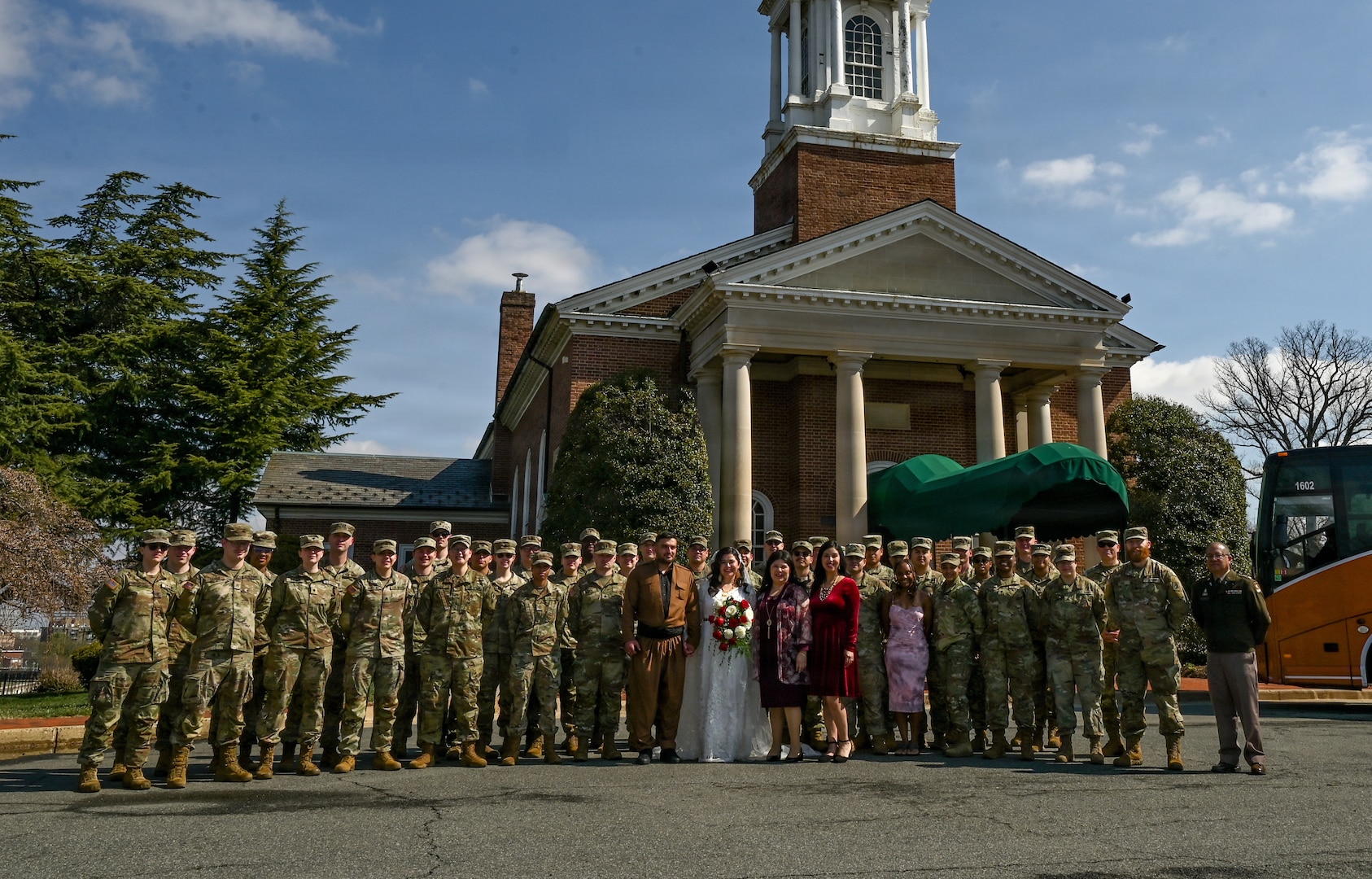 Indiana National Guard members pose for a photo after a wedding ceremony at the Old Post Chapel on Fort Myer, Virginia, March 21, 2026. About 2,700 National Guard members support the D.C. Safe and Beautiful mission, assisting the Metropolitan Police Department in maintaining public safety for residents, commuters and visitors throughout the District.