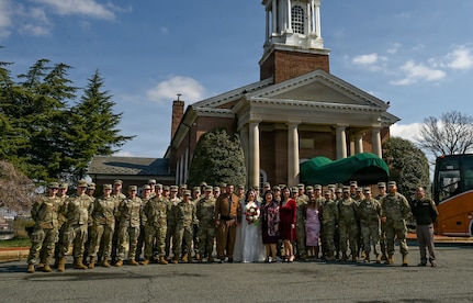 Indiana National Guard members pose for a photo after a wedding ceremony at the Old Post Chapel on Fort Myer, Virginia, March 21, 2026. About 2,700 National Guard members support the D.C. Safe and Beautiful mission, assisting the Metropolitan Police Department in maintaining public safety for residents, commuters and visitors throughout the District.