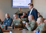 John Griese, senior wargame designer and facilitator supporting the National Guard Bureau’s Wargaming and Analysis Branch, addresses Wisconsin Department of Military Affairs personnel taking part in the National Guard’s Presidio Endeavor wargame at the Armed Forces Reserve Center in Madison, Wisconsin, March 12, 2026.