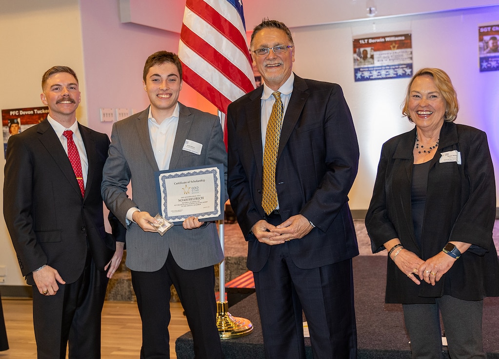 Noah Helfrich, second from left, is presented a Gold Star Mission scholarship in memory of Sgt. Franklin Bennett during the Gold Star Mission scholarship banquet in Springfield March 21.